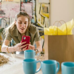 A Woman Taking Photo of a Mug